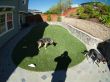 Stone retaining walls & artificial grass lawn installed in a backyard in Novato, California.